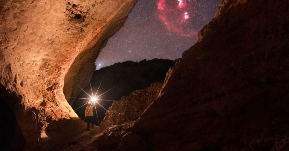 Hikes - Person Walking with Flashlight among Rocks at Night