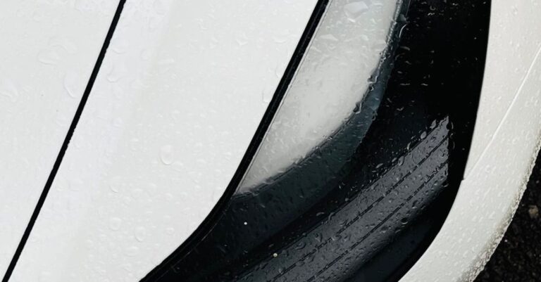 Headlamp - A close up of a white car's headlights