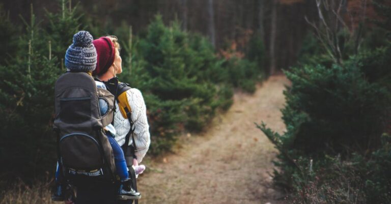 Hike - Shallow Focus on Blond Haired Woman in White Long Sleeve Shirt Carrying a Baby on Her Back